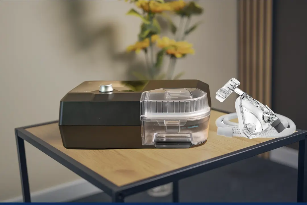 Close-up of quiet CPAP machine on bedside table with digital screen showing low noise mode