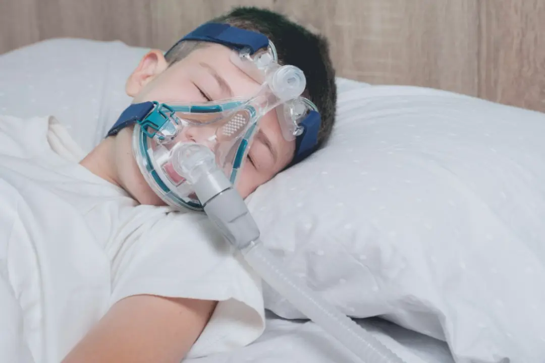 Child sleeping with pediatric CPAP mask